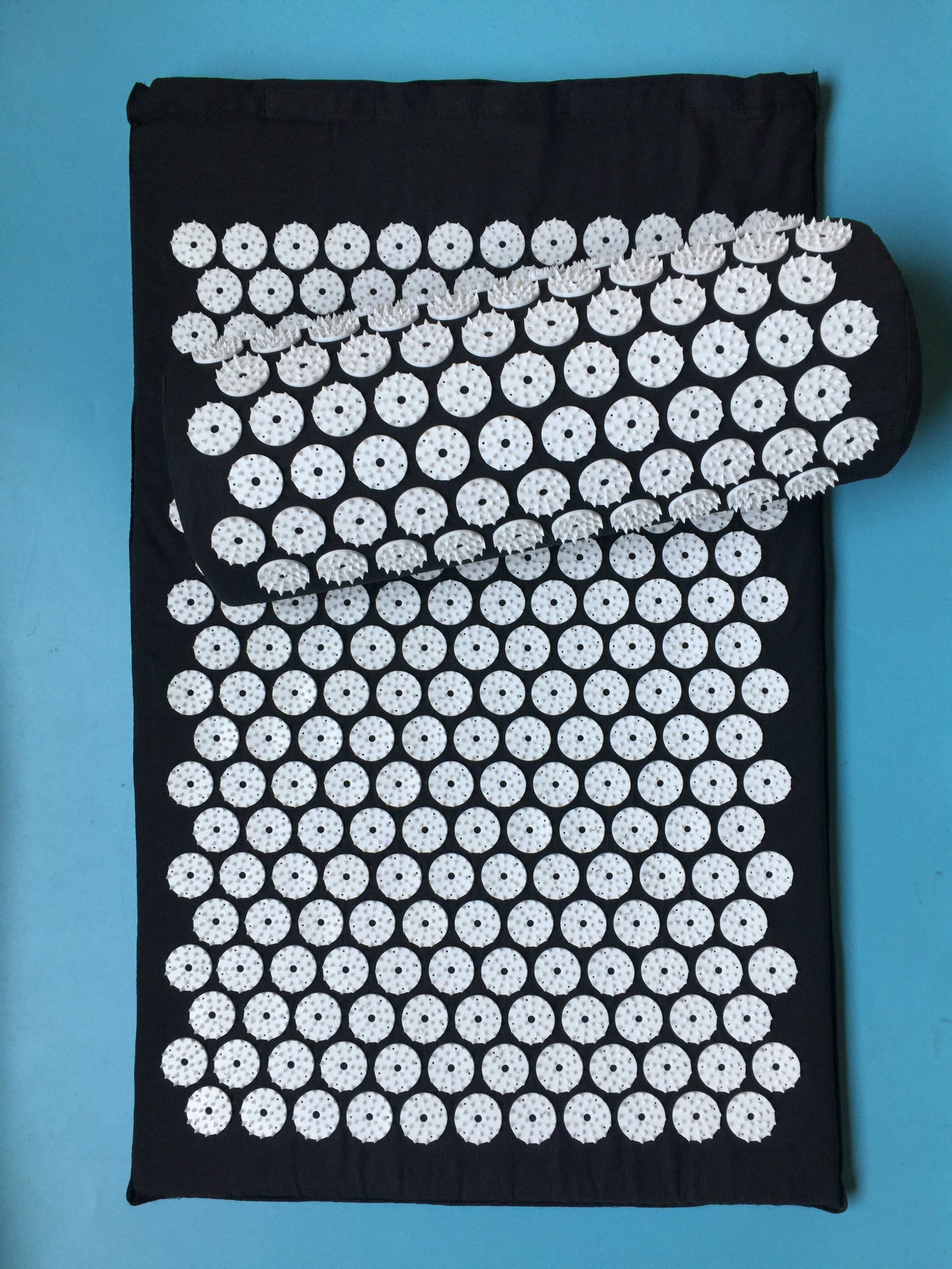 Capilorix acupuncture yoga cushion and massage pillow, designed for activewear jumpsuits, with a soft, supportive fabric and ergonomic shape.