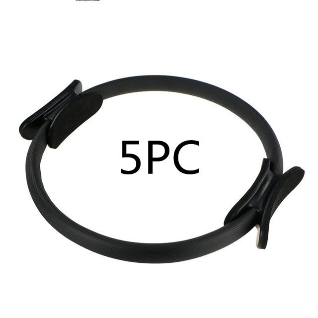 Capilorix yoga fitness Pilates ring used for resistance exercises, held by a woman in activewear jumpsuit during home workout session.