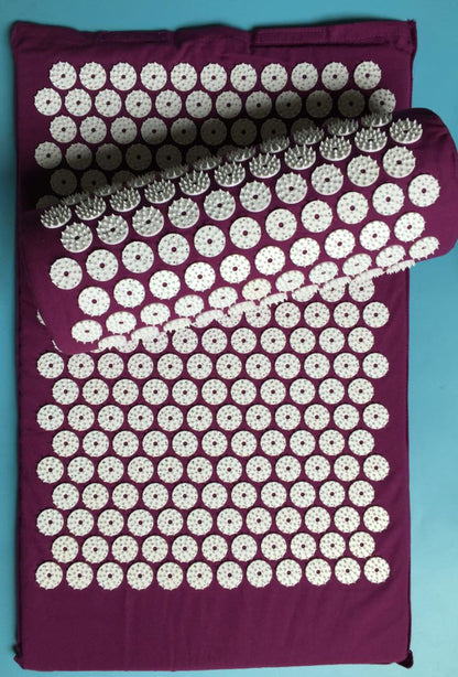 Capilorix acupuncture yoga cushion and massage pillow with activewear jumpsuit in the background, designed for comfort and relaxation.