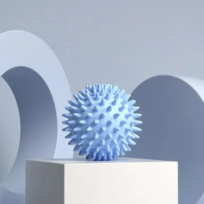 Capilorix hedgehog massage ball used for yoga, muscle relaxation, and fascia release on shoulders, neck, and legs.